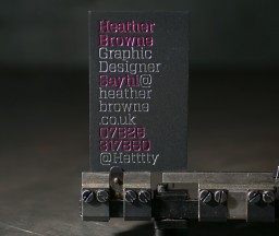 Metallic foil stamped business cards on black museum board paper